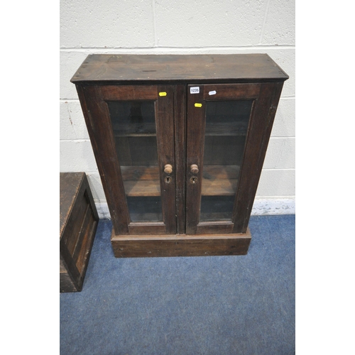 1235 - A STAINED PINE CABINET, with double glazed doors, width 79cm x depth 31cm x height 107cm, along with... 