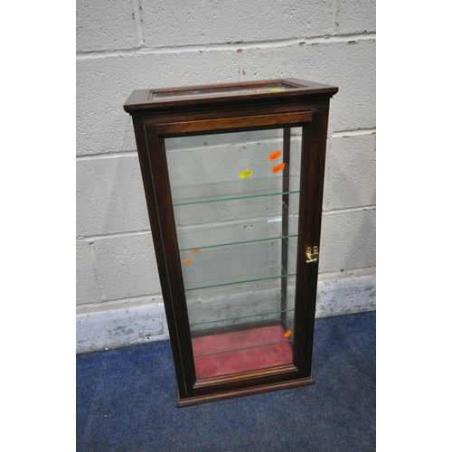 1238 - AN EARLY 20TH CENTURY MAHOGANY DISPLAY CABINET, the single door enclosing a glass shelf, above a sin... 