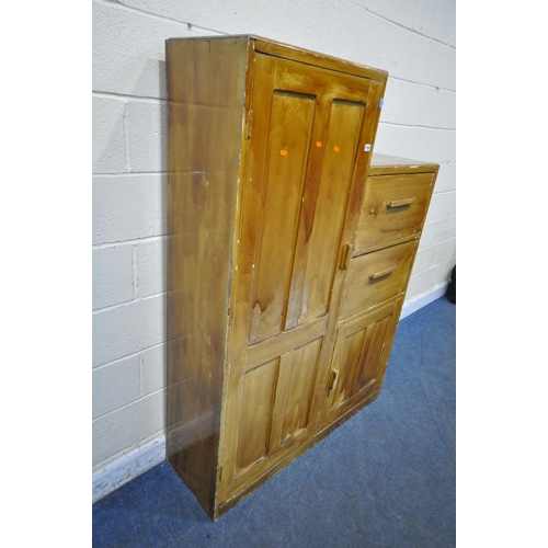 1255 - A 20TH CENTURY STAINED PINE GENTLEMAN'S WARDROBE, with a single large door, a single small door and ... 