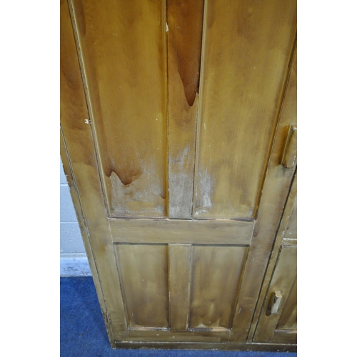 1255 - A 20TH CENTURY STAINED PINE GENTLEMAN'S WARDROBE, with a single large door, a single small door and ... 