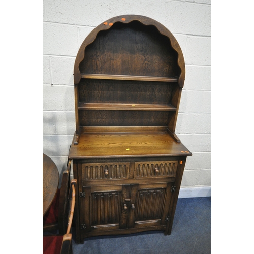 1258 - A 20TH CENTURY OAK DROP LEAF TABLE, raised on trestle legs, united by a stretcher, diameter 122cm x ... 