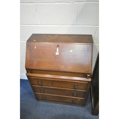 1259 - AN EARLY 2OTH CENTURY OAK BOOKCASE, the fall front door enclosing a fitted interior, above three dra... 