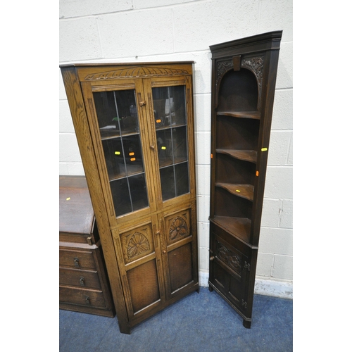 1259 - AN EARLY 2OTH CENTURY OAK BOOKCASE, the fall front door enclosing a fitted interior, above three dra... 