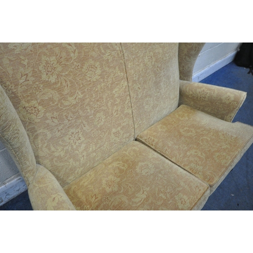 1264 - A PARKER KNOLL WING BACK TWO SEATER SOFA, width 136cm x depth 87cm x height 98cm, along with a foots... 