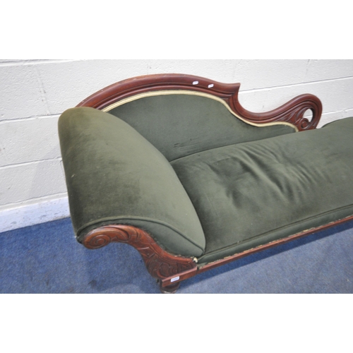 1265 - AN EARLY 20TH CENTURY CHAISE LOUNGE, with scrolled backrest, green upholstery, raised on turned legs... 