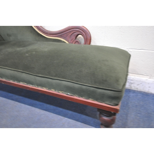 1265 - AN EARLY 20TH CENTURY CHAISE LOUNGE, with scrolled backrest, green upholstery, raised on turned legs... 