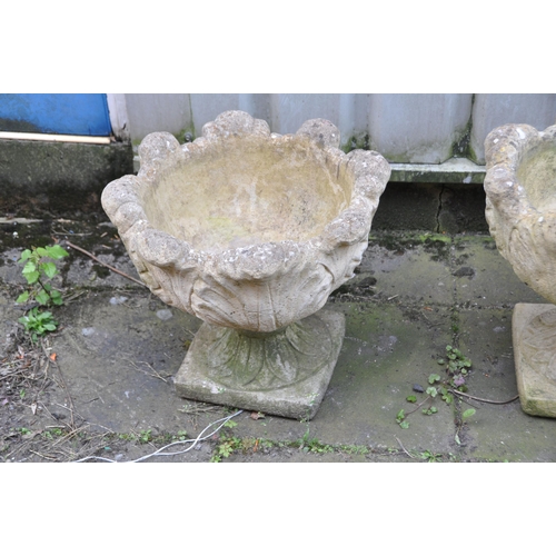 1005 - A PAIR OF MODERN COMPOSITE GARDEN URNS with foliate detail to bowls both in two sections 46cm in dia... 