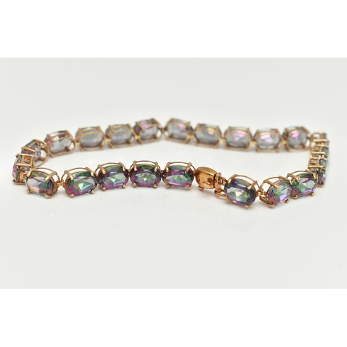 20 - A 9CT GOLD MYSTIC TOPAZ LINE BRACELET, designed as a series of twenty-two oval cut, mystic coated to... 