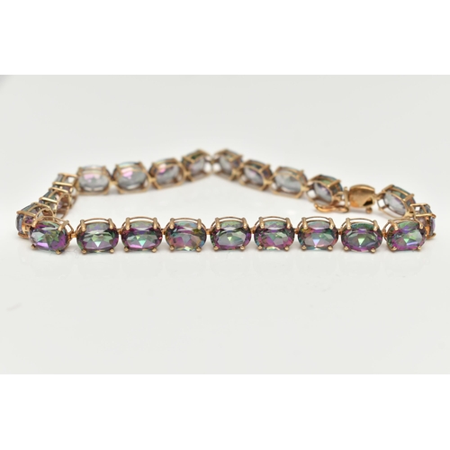 20 - A 9CT GOLD MYSTIC TOPAZ LINE BRACELET, designed as a series of twenty-two oval cut, mystic coated to... 