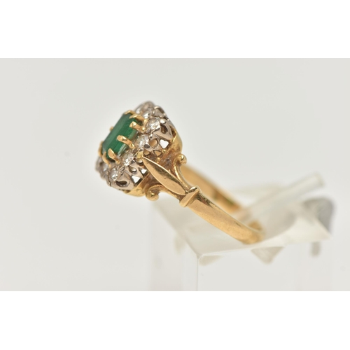 24 - A YELLOW METAL EMERALD AND DIAMOND CLUSTER RING, of a rectangular form, set to the centre with an em... 