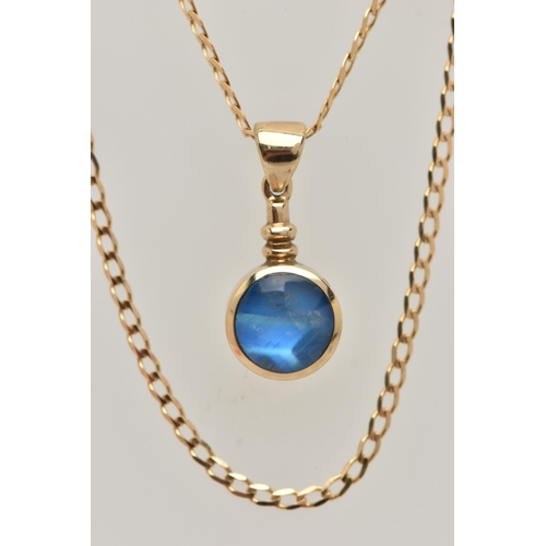 27 - A 9CT GOLD GEM SET PENDANT AND CHAIN, the circular pendant set with a blue sheen cabochon, possibly ... 