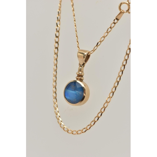 27 - A 9CT GOLD GEM SET PENDANT AND CHAIN, the circular pendant set with a blue sheen cabochon, possibly ... 