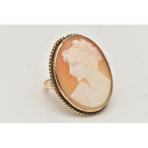 3 - A YELLOW METAL CAMEO RING, large oval carved shell cameo depicting a lady in profile, collet set wit... 