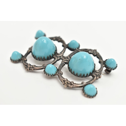 30 - A WHITE METAL BROOCH, open work brooch set with two large blue ceramic domes and six smaller domes, ... 