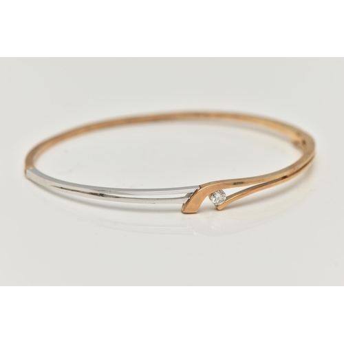 32 - A MODERN 9CT YELLOW AND WHITE GOLD DIAMOND BANGLE, the hinged bangle set with a round brilliant-cut ... 