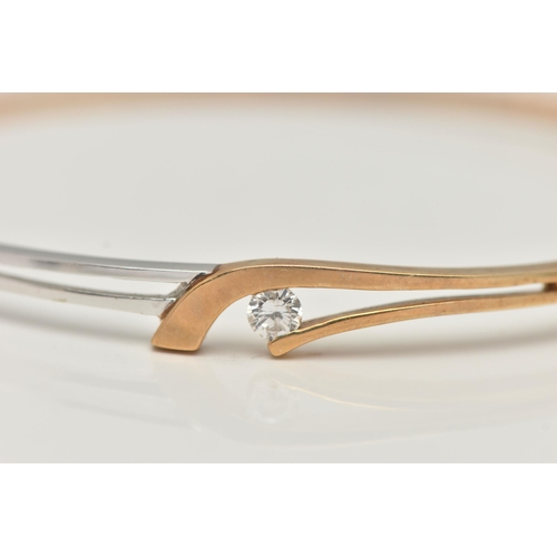 32 - A MODERN 9CT YELLOW AND WHITE GOLD DIAMOND BANGLE, the hinged bangle set with a round brilliant-cut ... 