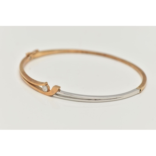 32 - A MODERN 9CT YELLOW AND WHITE GOLD DIAMOND BANGLE, the hinged bangle set with a round brilliant-cut ... 