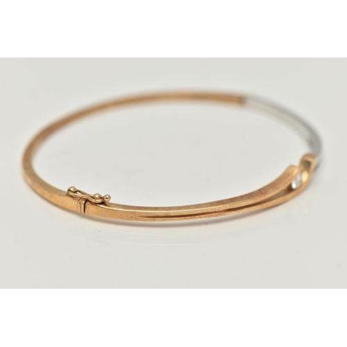 32 - A MODERN 9CT YELLOW AND WHITE GOLD DIAMOND BANGLE, the hinged bangle set with a round brilliant-cut ... 