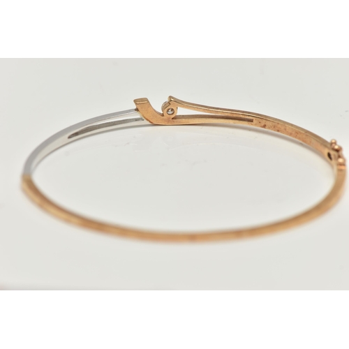 32 - A MODERN 9CT YELLOW AND WHITE GOLD DIAMOND BANGLE, the hinged bangle set with a round brilliant-cut ... 