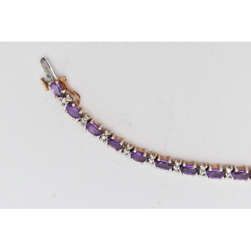 36 - A 9CT YELLOW AND WHITE GOLD AMETHYST AND DIAMOND BRACELET, designed as a series of twenty six oval s... 