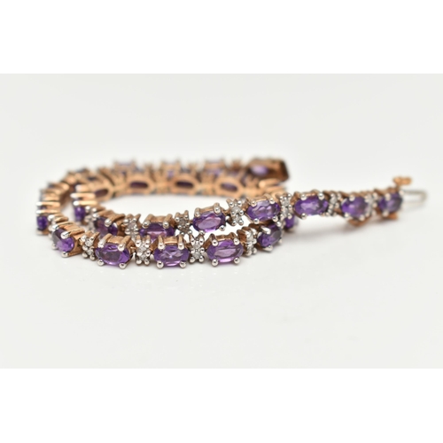 36 - A 9CT YELLOW AND WHITE GOLD AMETHYST AND DIAMOND BRACELET, designed as a series of twenty six oval s... 