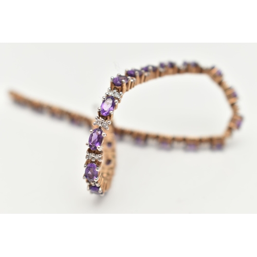 36 - A 9CT YELLOW AND WHITE GOLD AMETHYST AND DIAMOND BRACELET, designed as a series of twenty six oval s... 