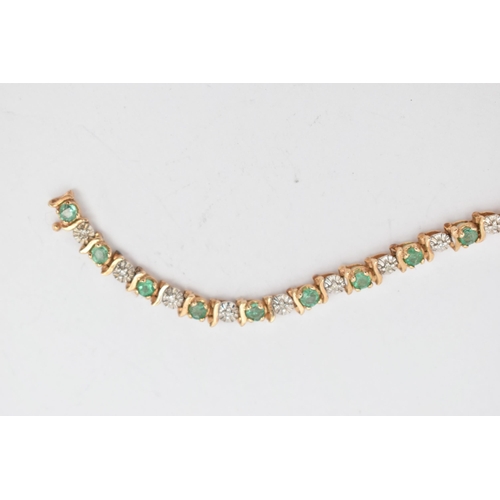 37 - A 9CT GOLD EMERALD AND DIAMOND BRACELET, designed as a series of approximately twenty four emeralds,... 