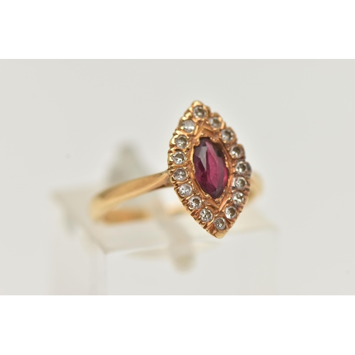 44 - AN 18CT GOLD RUBY AND DIAMOND RING, a marquise cut ruby prong set in yellow gold, set with a surroun... 