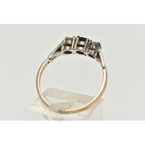 103 - A SILVER GILT THREE STONE RING, set with a central circular cut blue sapphire, flanked with two colo... 