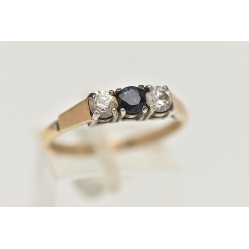 103 - A SILVER GILT THREE STONE RING, set with a central circular cut blue sapphire, flanked with two colo... 