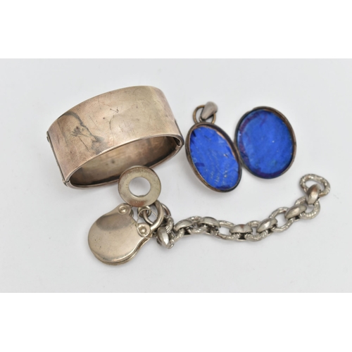 117 - THREE ITEMS OF WHITE METAL JEWELLERY, to include a wide hinged bangle, fitted with a push button cla... 