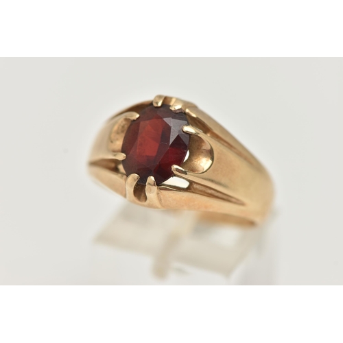 77 - A GENTS 9CT GOLD GARNET RING, gypsy set, oval cut garnet, to a polished band, hallmarked 9ct possibl... 