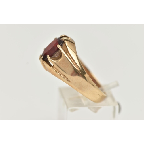 77 - A GENTS 9CT GOLD GARNET RING, gypsy set, oval cut garnet, to a polished band, hallmarked 9ct possibl... 