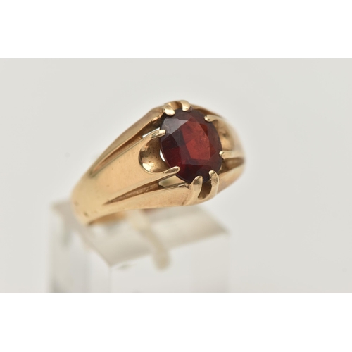 77 - A GENTS 9CT GOLD GARNET RING, gypsy set, oval cut garnet, to a polished band, hallmarked 9ct possibl... 