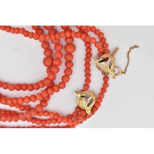 92 - A CORAL BEAD NECKLACE, triple strand of round polished graduated coral beads, fitted with a yellow m... 