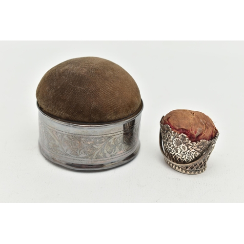 158 - TWO PIN CUSHIONS, the first a circular form silver pin cushion with acanthus scrolled detail with pe... 