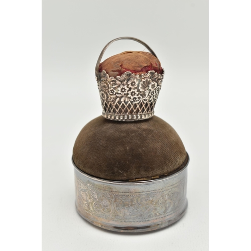 158 - TWO PIN CUSHIONS, the first a circular form silver pin cushion with acanthus scrolled detail with pe... 