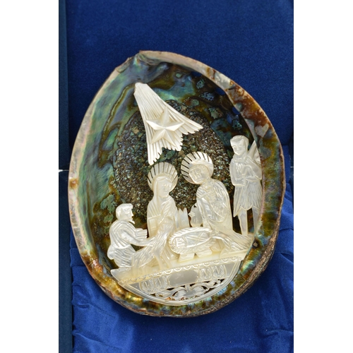 199 - A CARVING AND NATURAL SPECIMENS, a cased abalone shell with a carved mother of pearl nativity scene,... 