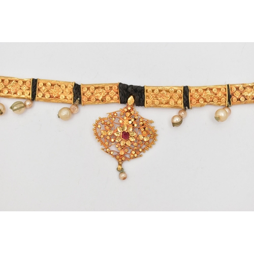 212 - AN INDIAN NECKLACE, designed with a central fancy floral and beaded pendant with central ruby suspen... 