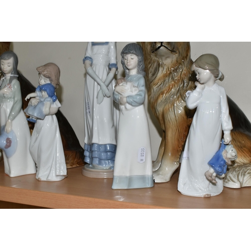 324 - FIVE NAO FIGURES AND TWO FIGURES OF GERMAN SHEPHERD DOGS, the Nao figures comprising a girl with a p... 