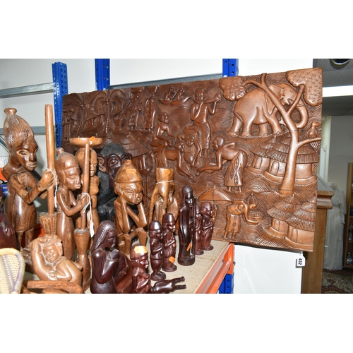 432 - A LARGE COLLECTION OF HAND CRAFTED AFRICAN WOOD STATUES FROM LIBERIA ETC, including a large panel de... 