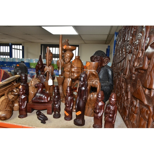 432 - A LARGE COLLECTION OF HAND CRAFTED AFRICAN WOOD STATUES FROM LIBERIA ETC, including a large panel de... 