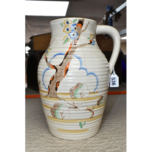 536 - A CLARICE CLIFF SINGLE HANDLED LOTUS JUG, in Tiger Tree pattern, painted with a stylised tree on a c... 