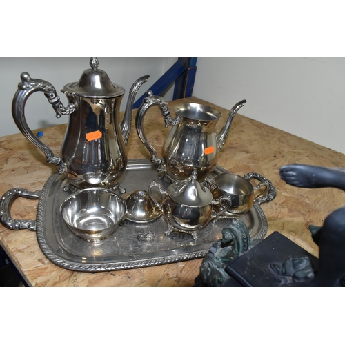 548 - A FIGURAL MANTEL CLOCK AND AN ONEIDA PLATED TEA AND COFFEE SET, comprising a resin figural mantel cl... 