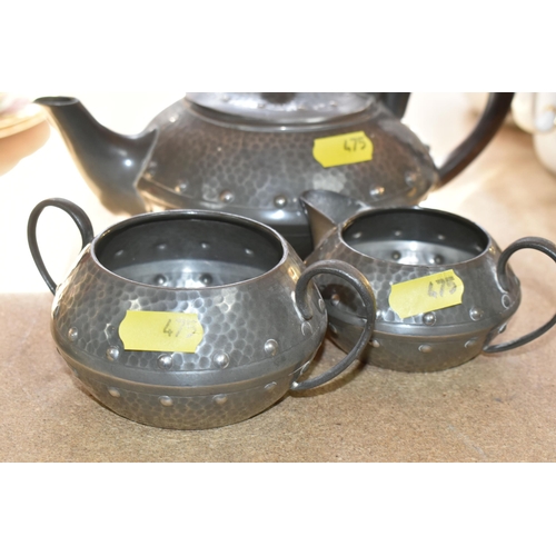 475 - AN EARLY 20TH CENTURY ARTS & CRAFTS PLANISHED PEWTER TEA SET, comprising teapot, hot water jug, milk... 