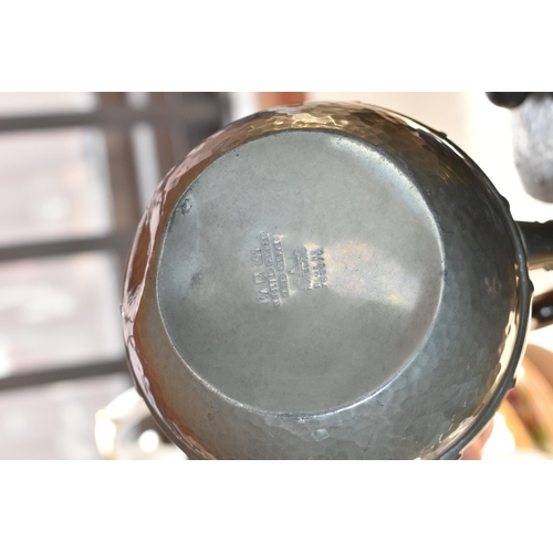 475 - AN EARLY 20TH CENTURY ARTS & CRAFTS PLANISHED PEWTER TEA SET, comprising teapot, hot water jug, milk... 