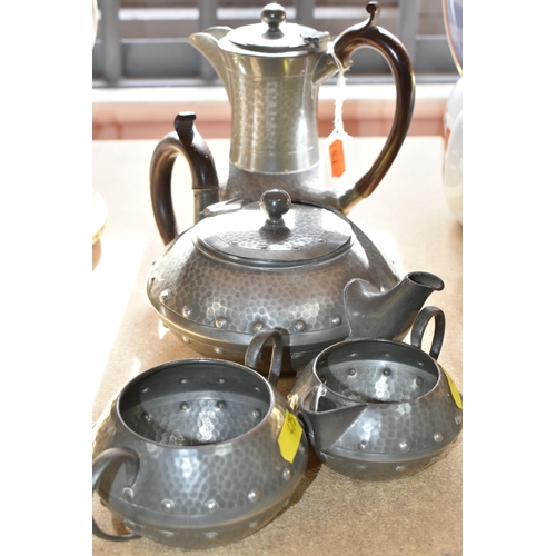 475 - AN EARLY 20TH CENTURY ARTS & CRAFTS PLANISHED PEWTER TEA SET, comprising teapot, hot water jug, milk... 