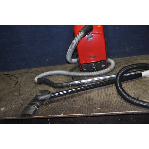 1055 - A MIELE CAT AND DOG VACUUM CLEANER (no floor head) and a Tesco vacuum cleaner ( pipework taped over ... 