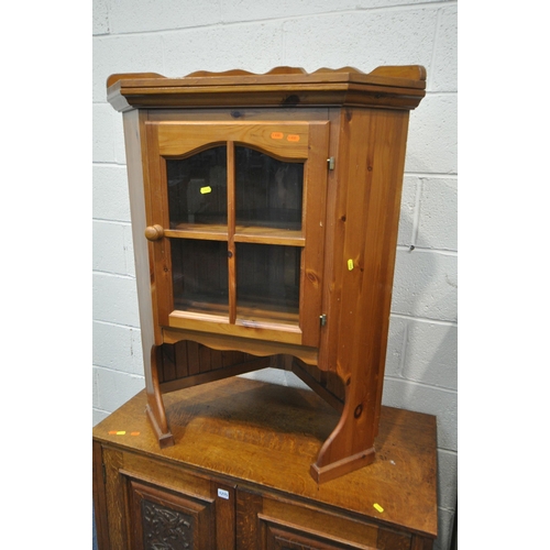 1215 - AN OAK TWO DOOR CUPBOARD, with carved foliate panels, width 100cm x depth 49cm x height 75cm, along ... 