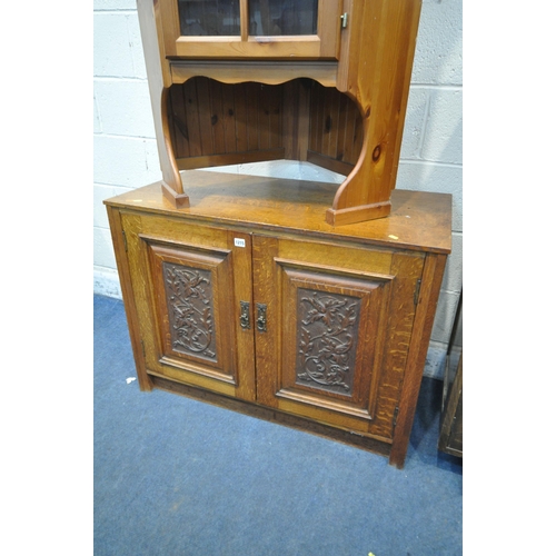 1215 - AN OAK TWO DOOR CUPBOARD, with carved foliate panels, width 100cm x depth 49cm x height 75cm, along ... 